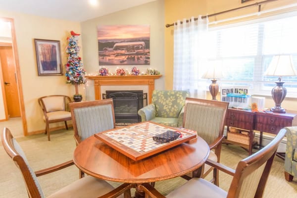 Cozy common area with a game table and fireplace