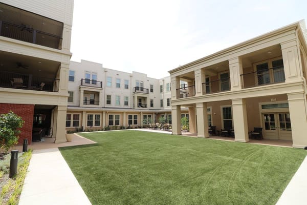 Outdoor area with landscaped green space and buildings