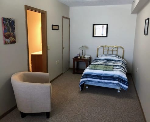 Private resident room with a bed and seating area