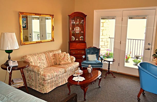 Cozy lounge area with floral furniture and natural light
