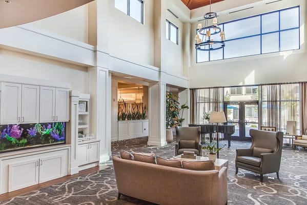 Bright lobby area with comfortable seating and an aquarium