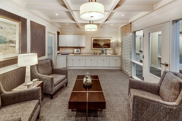 Bright common area with seating and kitchenette