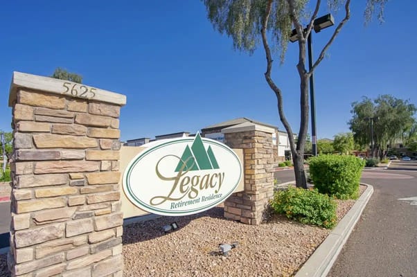 Signage for Legacy Retirement Residence with mountains