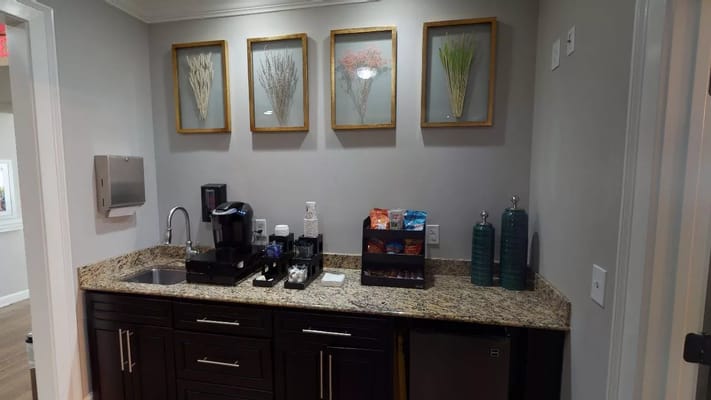 Coffee station with framed botanical art on the wall