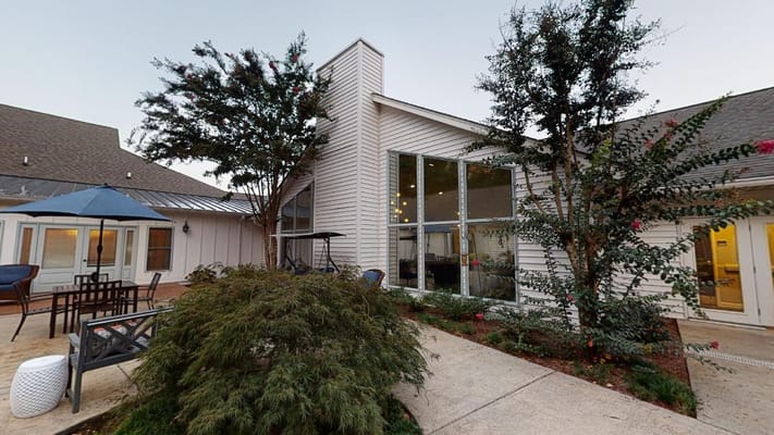 Exterior view of a senior living facility with seating areas