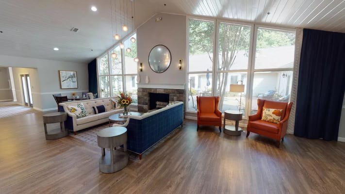 Comfortable common area with seating near large windows