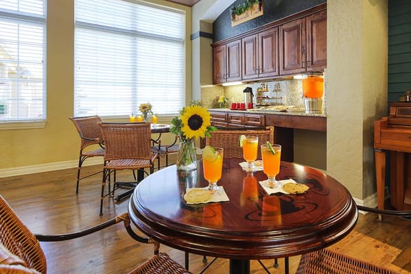 A table with drinks and snacks in a cozy lounge area