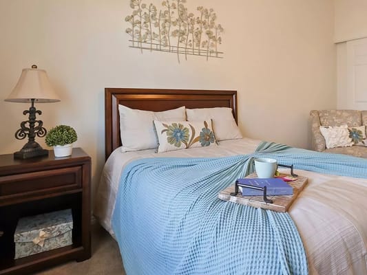 Inviting bedroom with a bed, lamp, and decorative accents.