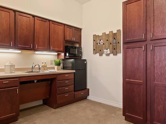 Cozy kitchen with wooden cabinets and appliances.