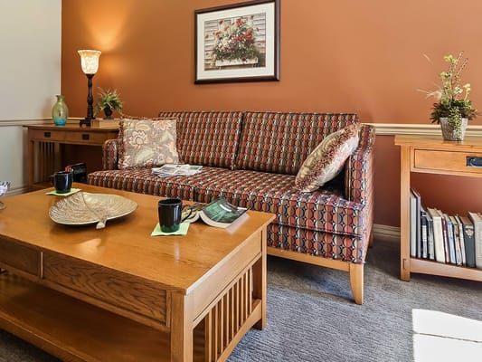 Cozy living room with a colorful couch and coffee table