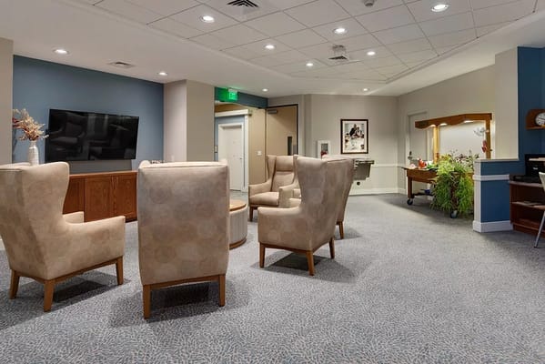 Interior view of a common area with chairs and TV