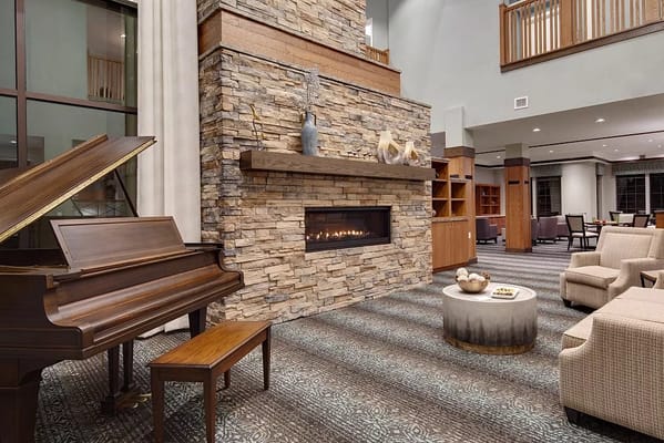 Cozy common area with a fireplace and piano