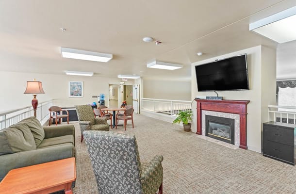 Common area with seating and fireplace in the facility