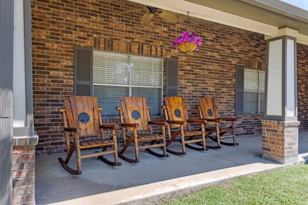 Four wooden rocking chairs on a porch