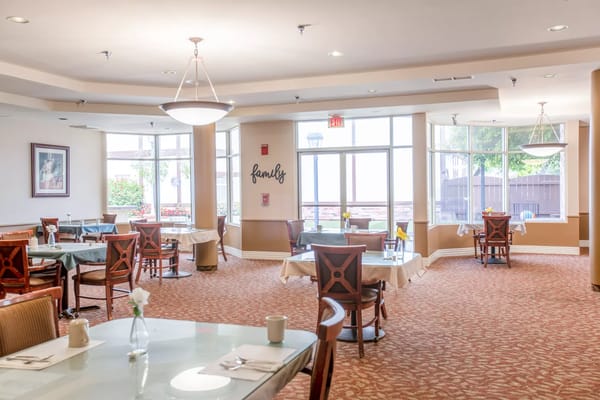 Bright dining room with tables set for meals