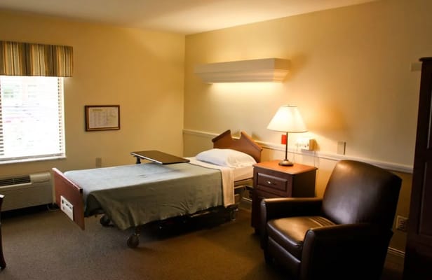 Cozy resident room with a bed and armchair