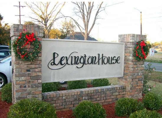 Sign of Lexington House with wreaths on either side