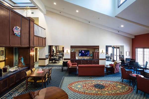 Spacious common area with seating and TV in Lexington Park Assisted Living