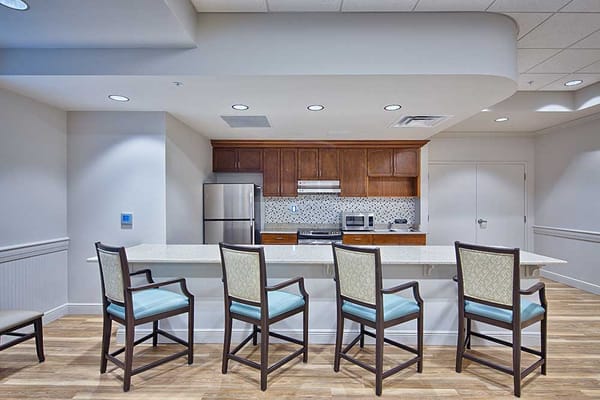 Interior kitchen area with bar seating and appliances