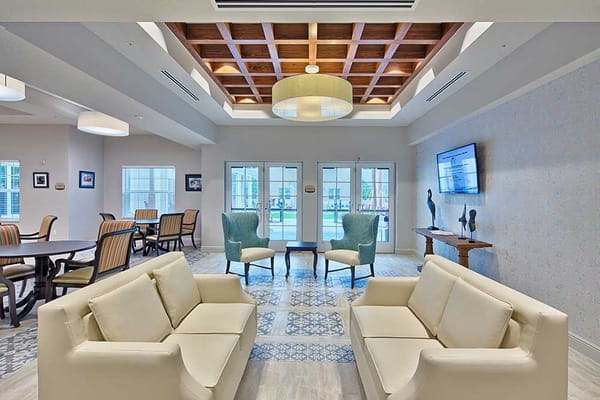 Bright common area with seating and dining tables