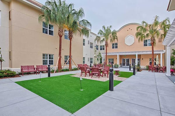 Outdoor patio area with seating and palms