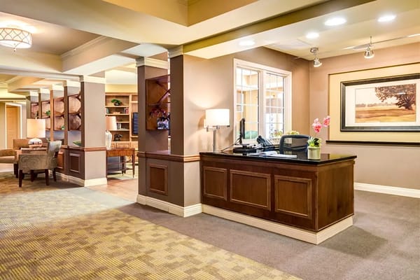 Cozy reception area with a wooden front desk and comfortable seating