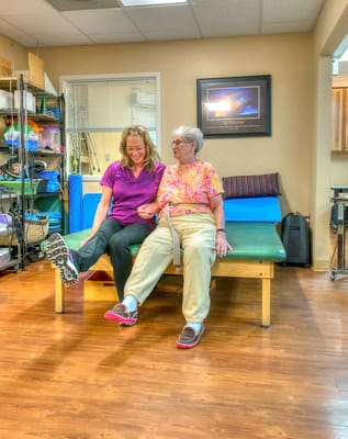 Therapist assisting a resident in an activity room