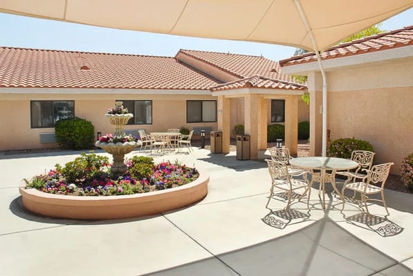 Serene outdoor patio featuring a fountain and chairs
