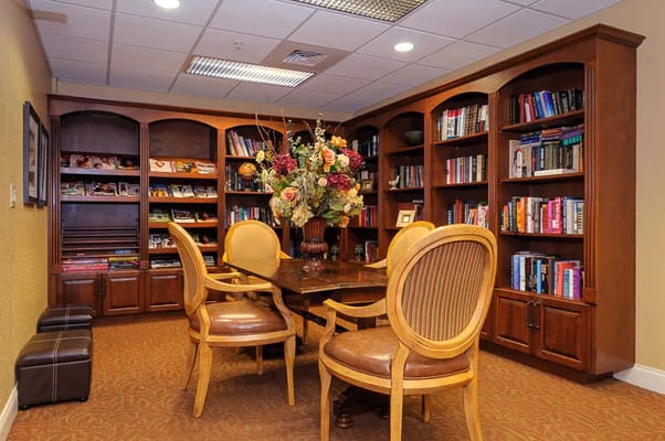 A cozy reading area with bookshelves and a table