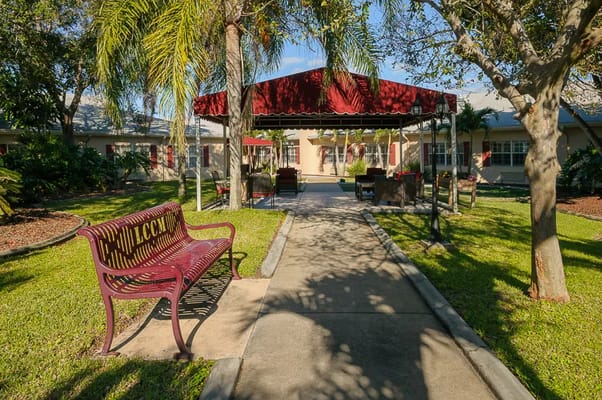 Pathway leading to an outdoor seating area in a landscaped garden