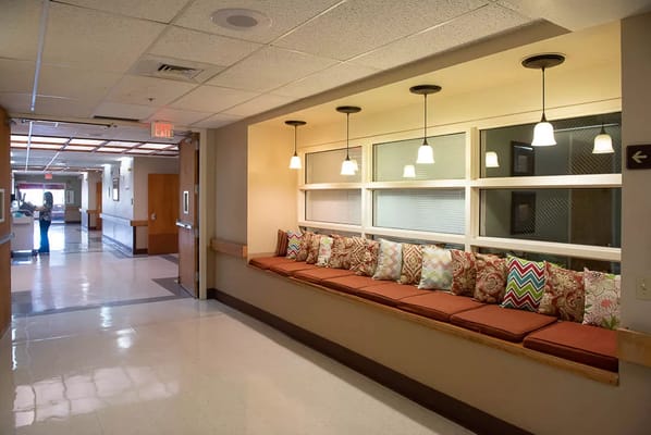 Interior hallway with a seating area and decorative pillows