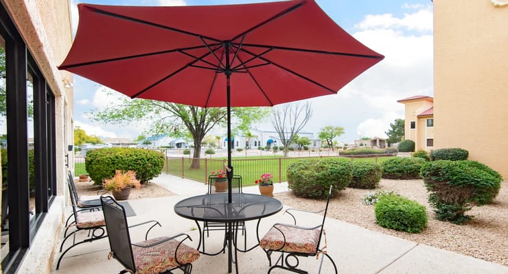 Outdoor seating area with umbrella and tables