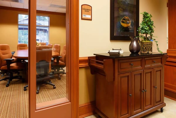 Interior of the conference room with a wooden cabinet and seating