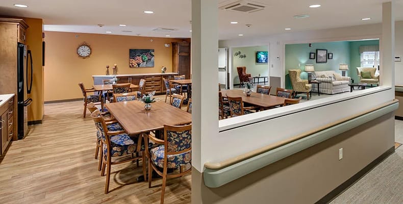 Dining area with wooden tables and floral chairs