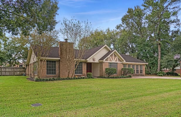 Exterior view of a senior living facility surrounded by trees