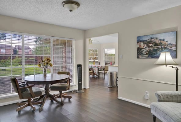 Bright common area with seating and views of the garden