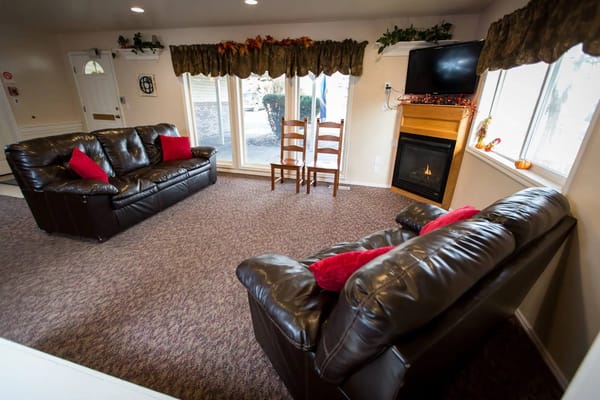Comfortable common area with seating and a fireplace