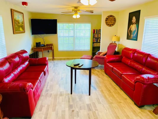 Bright common area with red sofas and decorative elements