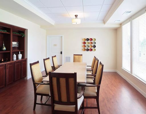 Bright dining area with large wooden table and chairs