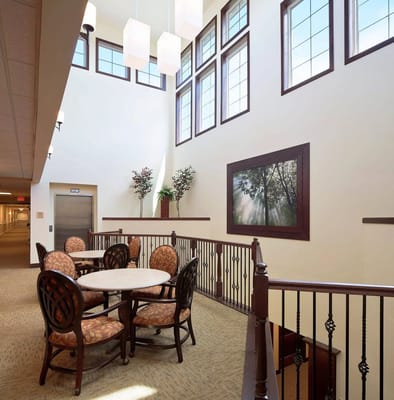 Bright common area with seating and large windows