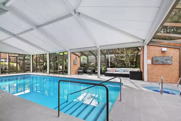 Indoor swimming pool area with lounge seating