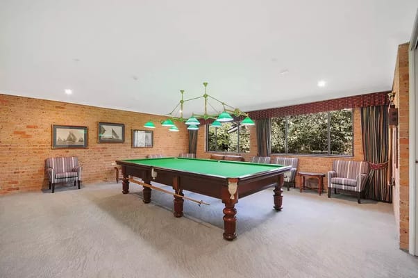 Interior game room with billiards table and seating