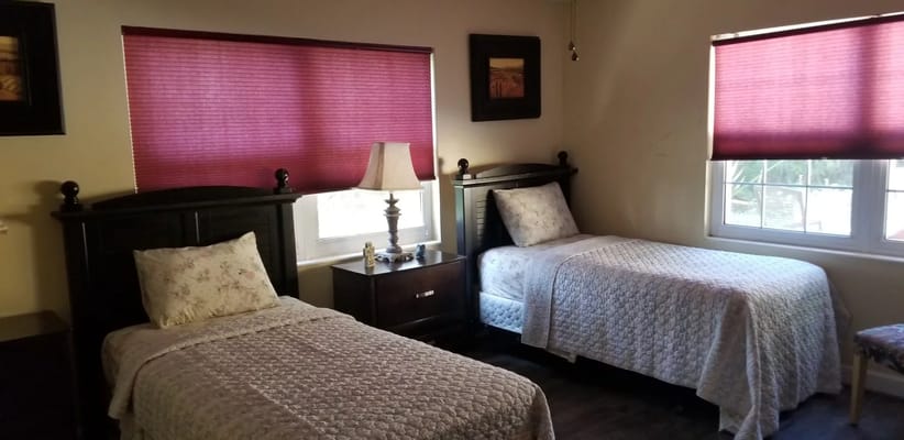 Brightly lit shared room with twin beds