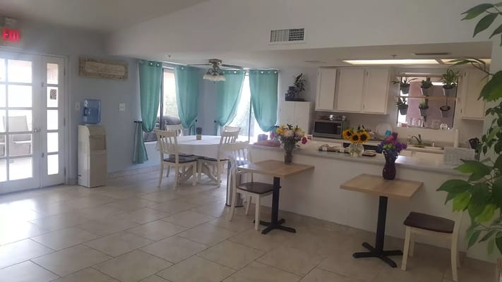 Bright common area with dining tables and decor