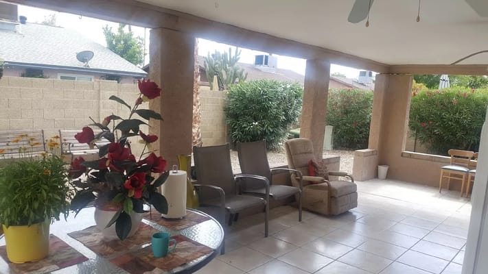 Outdoor patio area with seating and flowers