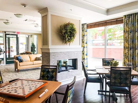 Cozy common area with seating and a fireplace at Maple Heights Senior Living.