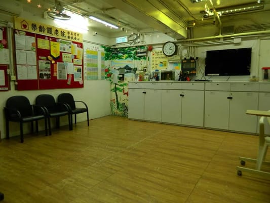 Interior view of the common area with chairs and wall decorations.