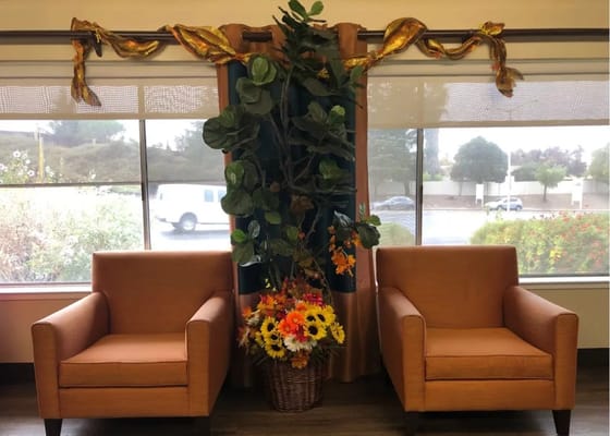 Common area with two chairs and floral decoration