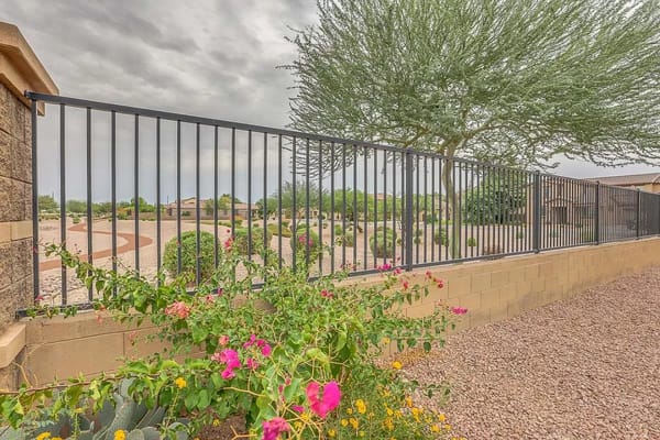 Colorful flowers and a fenced garden area at Lords Way Assisted Living