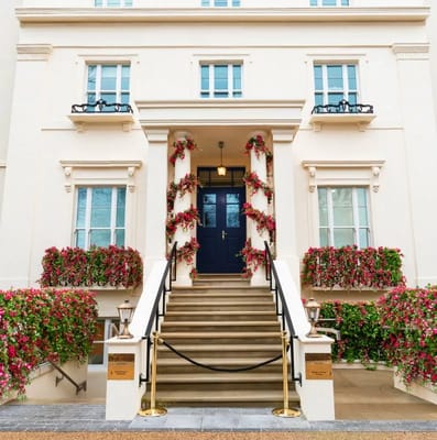 Exterior view of a beautifully landscaped entrance with stairs